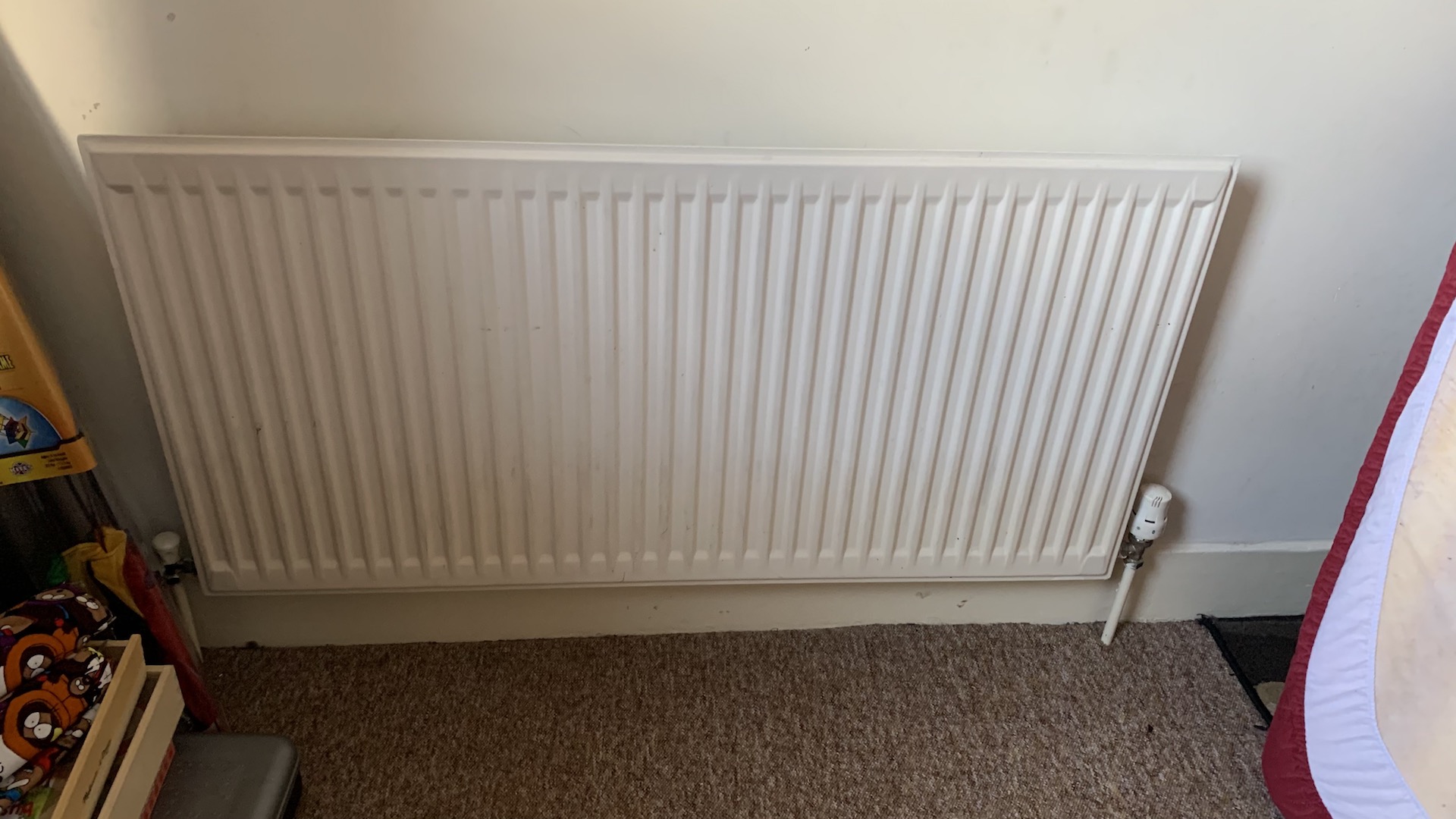 Photo showing white single panel radiator.